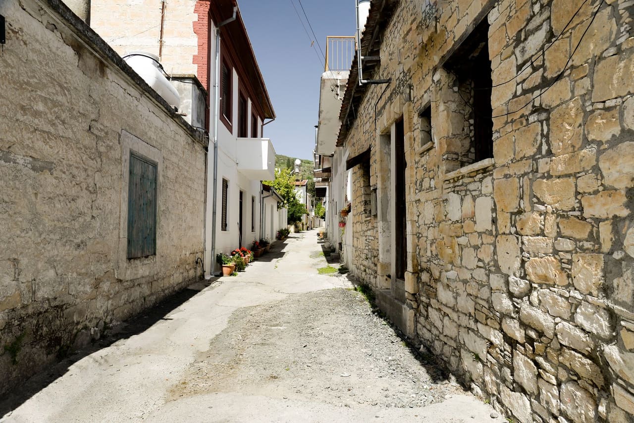 A stone-built village lane with potted flowers