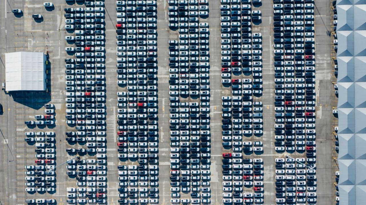 Aerial view of cars parked in long rows